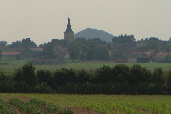 Des terres agricoles et un terril en arrière-plan d'un village du Béthunois.