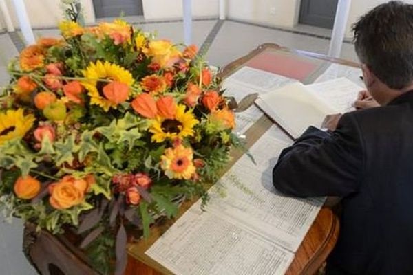 Un employé de la Fédération vaudoise des entrepreneurs écrit dans un livre de condoléances, le vendredi 3 octobre.