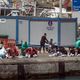 Des migrants sur le quai du port de Los Cristianos après avoir été secourus par les gardes-côtes de l'ile de Tenerife aux Canaries. Mars 2021.