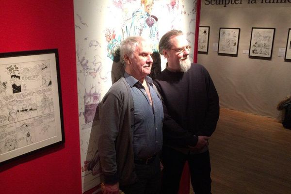 Hermann et son fils, Yves, devant les planches de la rétrospective de son oeuvre au festival de la BD d'Angoulême 2017.