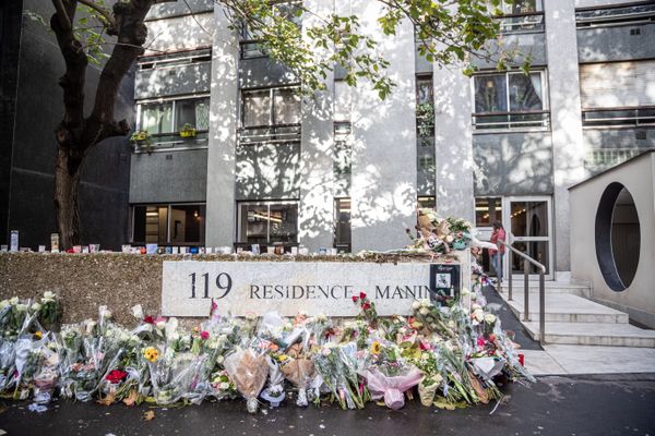 L'immeuble de Lola à Paris, avec un muret couvert de centaines de bouquets pour rendre hommage à la fillette, le 21 octobre 2022.