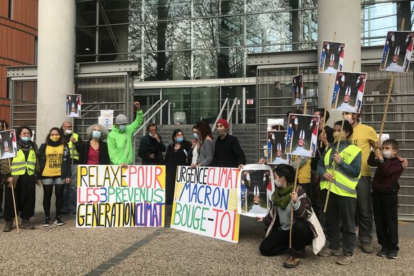 Des militants du mouvement ANV-COP21 devant le tribunal de Toulouse avec deux des prévenus poursuivis pour vol après avoir "décroché" un portrait d'Emmanuel Macron dans la mairie de Mérenvielle (Haute-Garonne)