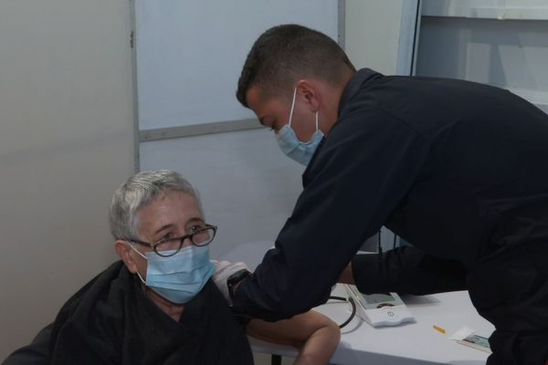 Un pompier de Paris délivre une dose de vaccin à une patiente ce samedi à Saint-Denis.