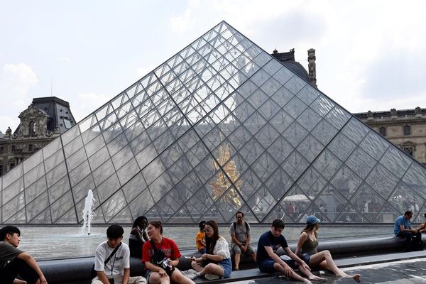 Des Parisiens devant la pyramide du Louvre, le 25 juillet 2018 en pleine vague de chaleur (illustration).