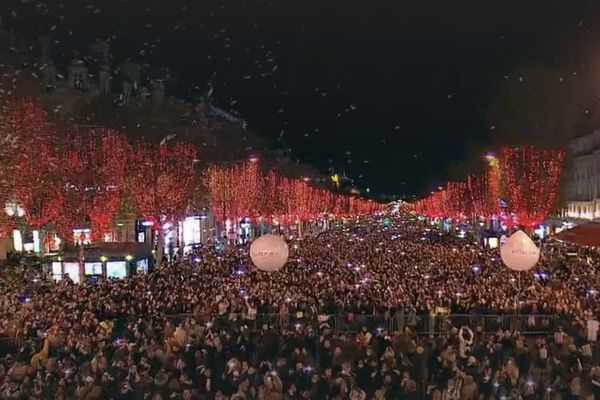 Les Champs-Elysées ont revêtu leur beau manteau rouge pourpre de Noël ce dimanche. Plusieurs milliers de personnes sont venus assister à l'événement.