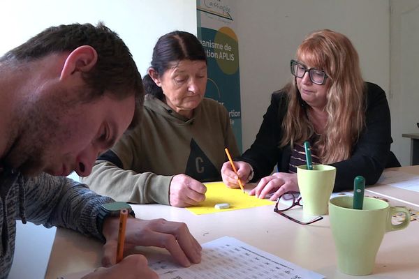 Marie-Joëlle et Ludovic participent à un atelier pour apprendre à lire et compter.