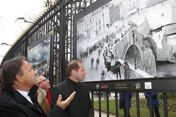 Jean-Pierre Bel, Président du Sénat accompagné de Christian Prudhomme, Président du Tour de France, sous une photo de l'exposition pour les 100 ans du Tour de France.