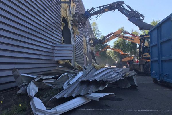 Les pelleteuses arrachent les façades des halls d'expositions. 