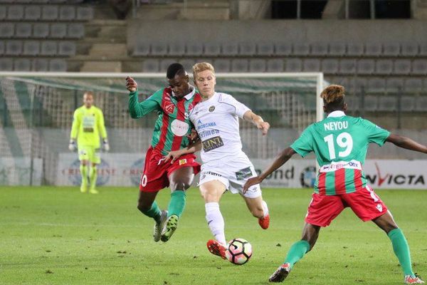 Jordan Gasser du FC Chambly aux prises avec 2 joueurs de Sedan vendredi soir.