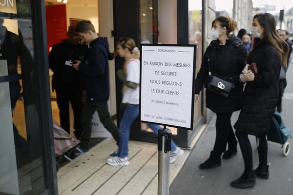 À Paris, un écriteau devant une boutique "Nous régulons le flux des clients"