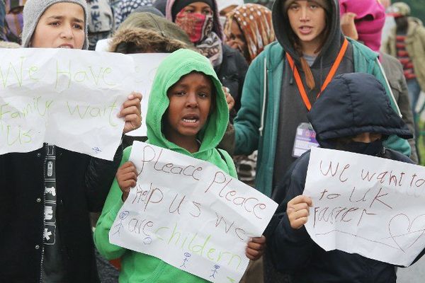 Des mineurs réclamant de l'aide, le mercredi 26 octobre à Calais.