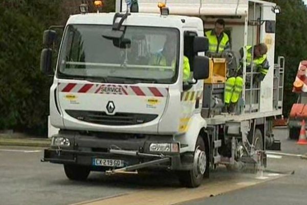 Ce camion de la société Aximum est chargé de réaliser une ligne discontinue sur la route.