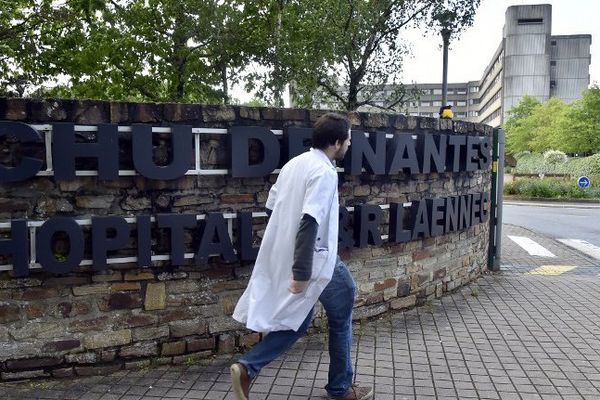 Un médecin passe devant l'entrée de l'hôpital Laënnec à Saint-Herblain près de Nantes où a probablement été implanté un nouveau cœur artificiel Carmat, essai clinique final devant permettre d'obtenir l'autorisation de commercialisation.