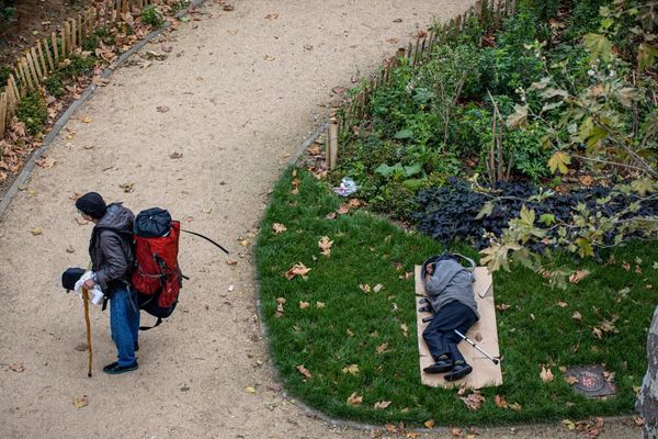 Un SDF assoupi dans un parc près de la place de la Chapelle à Paris, début octobre.