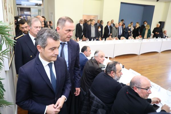 Gilles Simeoni et Gérald Darmanin rejoignent leur siège autour de la table des discussions.