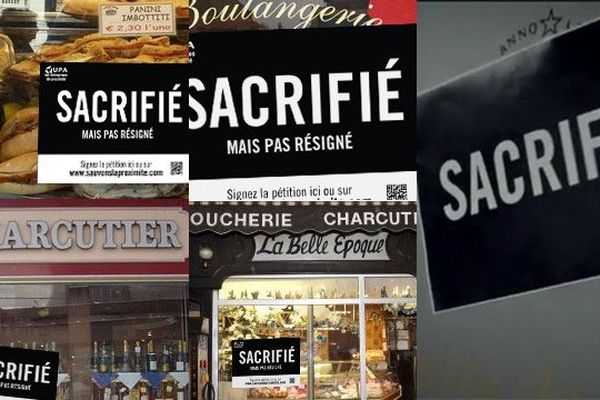 Des affichettes "Sacrifié mais pas résigné" sont apposés sur des vitrines de commerçants ou artisans. 