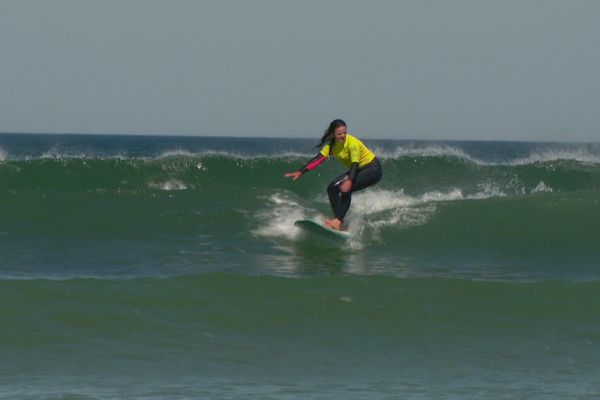 Une surfeuse goûte aux joies de la glisse, à la pointe de la Torche, Plomeur (29).