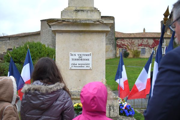 Le maire de Chateau-Larcher, Francis Gargouil, et de jeunes membres de la famille de Chloe Boissinot, devant la plaque qui vient d'être dévoilée en sa mémoire, le samedi 11 novembre 2017