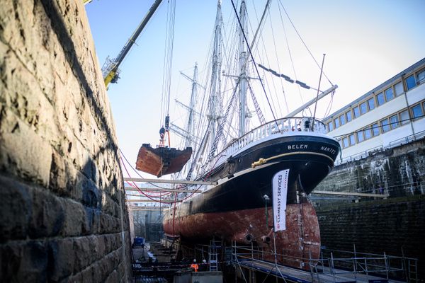 Un morceau de la coque du Belem, est soulevé par une grue lors de travaux de restauration le 13 février 2023 à Saint-Nazaire